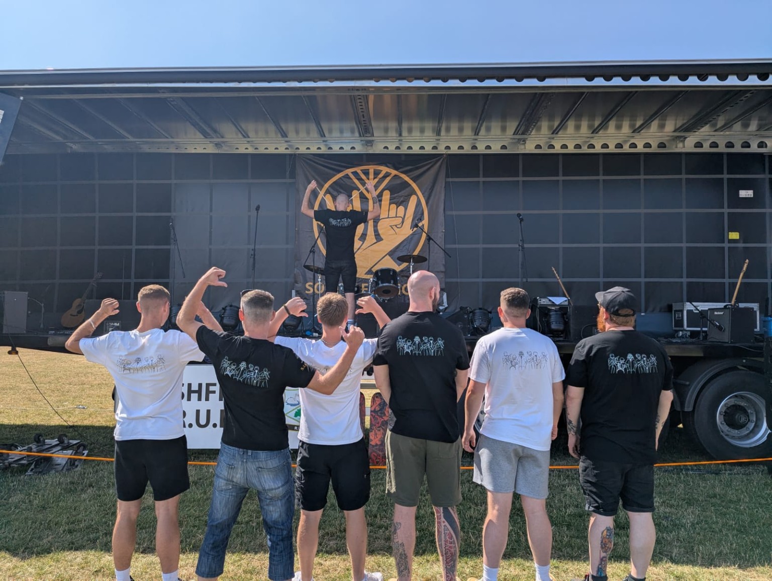 The six members of Sons of Jericho together in front of the stage